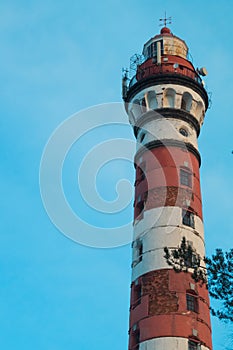 Lighthouse in the forest among the trees. red and white lighthouse