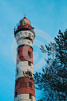 Lighthouse in the forest among the trees. red and white lighthouse