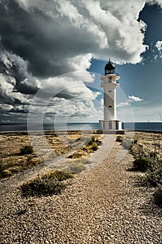 Lighthouse on the Formentera island, Spain, the blue sky with white clouds, without people, rocks, stones, sunny weather