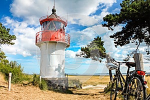 Lighthouse Gellen and bicycles. Sunny summer day. Hiddensee, Baltic Sea.