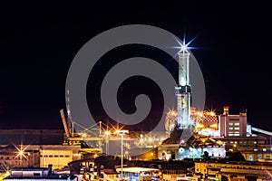 The lighthouse of Genoa by night, called Lanterna, symbol of the city, Italy. photo