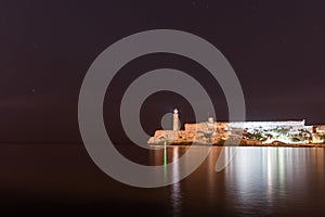 Lighthouse in Havana, Cuba. Morro Castle in background and Caribbean Sea.