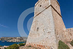 Lighthouse on a hill over Mediterranian sea. Scene view of sunny coastline photo