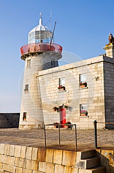 Lighthouse at Howth harbor in Ireland photo