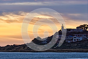 Lighthouse illuminated at sunrise on the cape. Cabo de las Huertas  Alicante. Spain photo