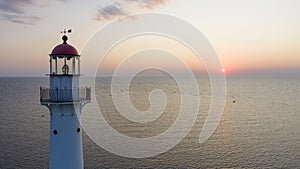 Lighthouse on the Kihnu island in Estonia during a beautiful sunset photo