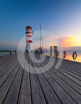 Lighthouse at Lake Neusiedl, Podersdorf am See, Burgenland, Austria. Lighthouse at sunset in Austria. Wooden pier with lighthouse