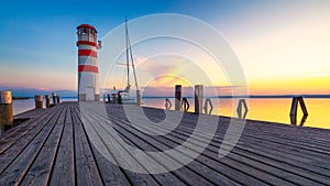 Lighthouse at Lake Neusiedl, Podersdorf am See, Burgenland, Austria. Lighthouse at sunset in Austria. Wooden pier with lighthouse