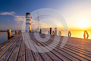 Lighthouse at Lake Neusiedl, Podersdorf am See, Burgenland, Austria. Lighthouse at sunset in Austria. Wooden pier with lighthouse