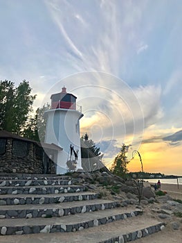 Lighthouse on the lake shore sunset sky