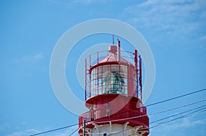 Lighthouse lamp over blue sky background