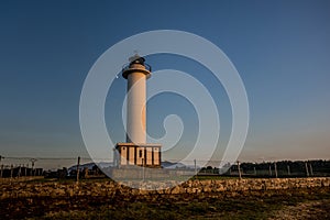 Lighthouse of Lastres with the fence on the foreground captured in the town of Luces, Spain photo