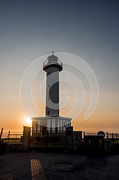 Lighthouse of Lastres at sunset captured in the town of Luces, Spain