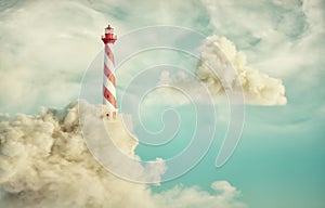 Lighthouse lit up on clouds. Dream concept