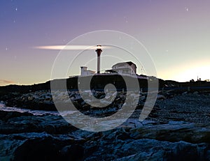 Lighthouse lit up in the starry night sky!