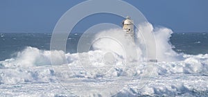 Lighthouse of the mangiabarche of calasetta in a stormy day, sardinia