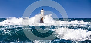 The lighthouse of the Mangiabarche shrouded by the waves of a mistral wind storm photo