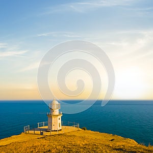 lighthouse on a marine cape at the evening