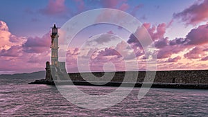 Lighthouse in the middle of a sea under a pink and blue clouded sky of Crete, Greece