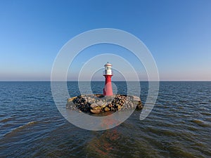 Lighthouse in Neringa, Klaipeda District, Lithuania. Baltic Sea in Background