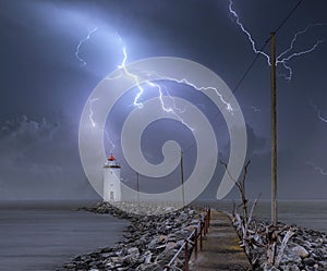 Lighthouse at night with lightning.