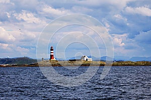 Lighthouse on Norwegian Islands in cloudy day