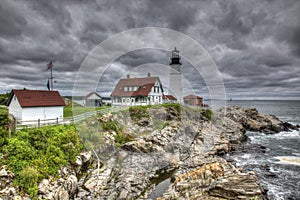 Lighthouse by Ocean on Rocks