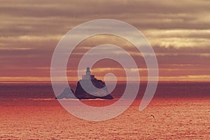 Lighthouse off Oregon coast at sunset