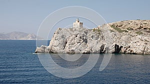 Lighthouse ormos harbor on the island of ios, greece