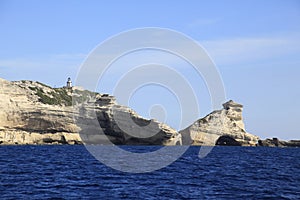 Lighthouse Pertusato overlooks a famous rock, Coast of Bonifacio, Corsica photo
