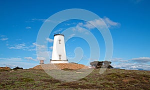 Lighthouse at Piedras Blancas point under sunset clouds on the Central Coast of California