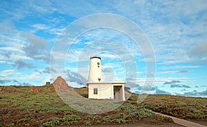 Lighthouse at Piedras Blancas point under sunset clouds on the Central Coast of California