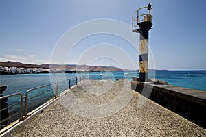 Lighthouse and pier boat in the blue sky arrecife