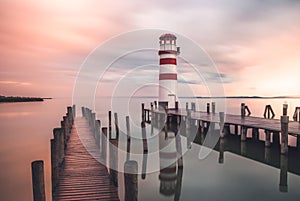 Lighthouse with a Pier at Sunrise