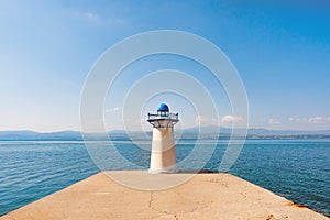 Lighthouse, pike, seamark on seascape background. Water transport background. Sea transportation. Travel concept. Voyage