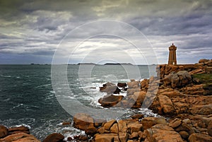 Ploumanac`h Mean Ruz lighthouse between the rocks in pink granite coast, Perros Guirec, Brittany, France.