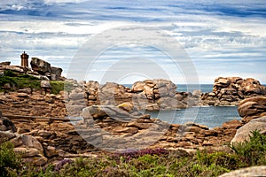 Ploumanac`h Mean Ruz lighthouse between the rocks in pink granite coast, Perros Guirec, Brittany, France.