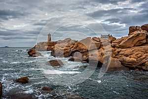 Ploumanac`h Mean Ruz lighthouse between the rocks in pink granite coast, Perros Guirec, Brittany, France.
