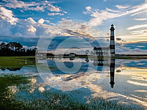 Lighthouse reflection in marshland water photo