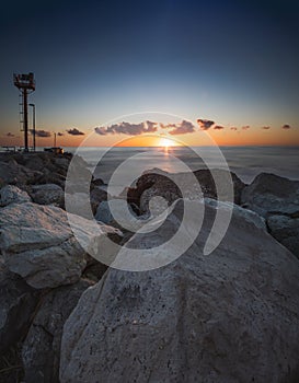 Lighthouse in Riccione port on the Adriatic sea at sunrise in summer
