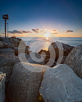 Lighthouse in Riccione port on the Adriatic sea at sunrise in summer