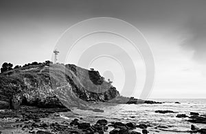 Lighthouse and rock beach at Laem Tanod Cape Koh Lanta, Krabi, Thailand Black and white photo