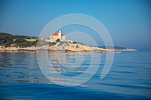 Lighthouse on rocks near island Vis in Dalmatia, Croatia