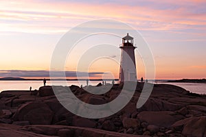 A lighthouse on a rocky coast at dusk