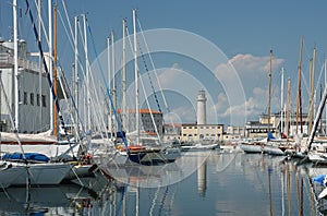 Lighthouse and sailboats in harbor in Trieste, Italy