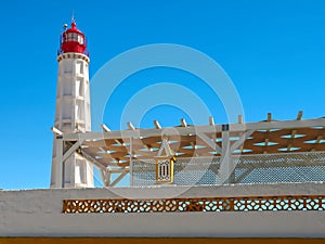 lighthouse Santa Maria of Farol Island at the Algarve coast of Portugal