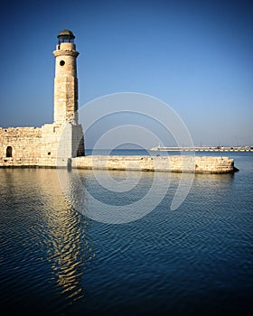 Lighthouse by sea against sky in Heraklion, Crete, Greece, June 2008 photo