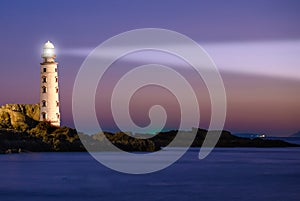 Lighthouse on sea sunset