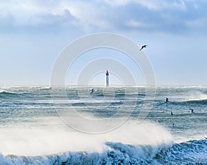 Lighthouse in the sea during windstorm with seagulls flight