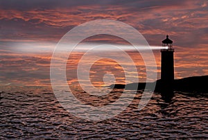 Lighthouse searchlight beam through marine air at night. photo